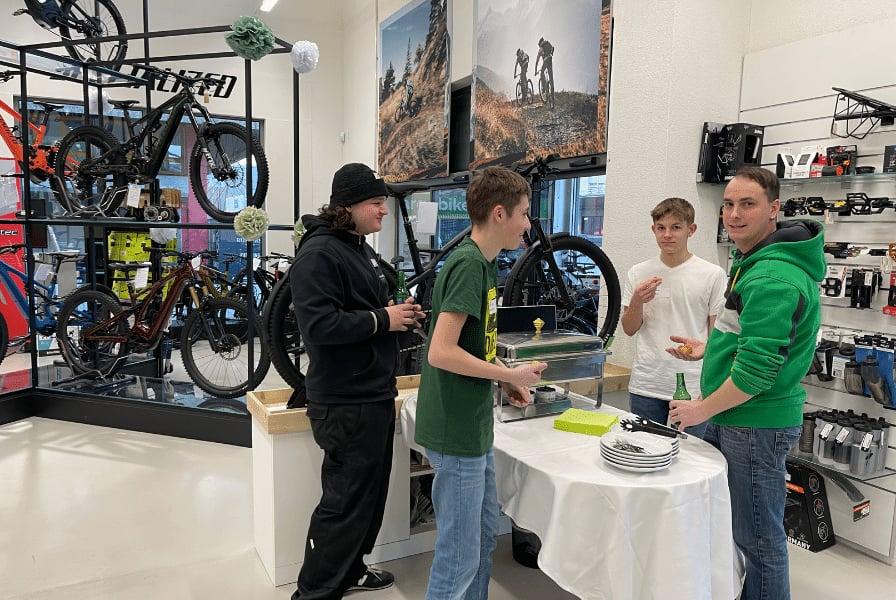 Personengruppe in Fahrradgeschäft mit E-Bikes und Zubehör