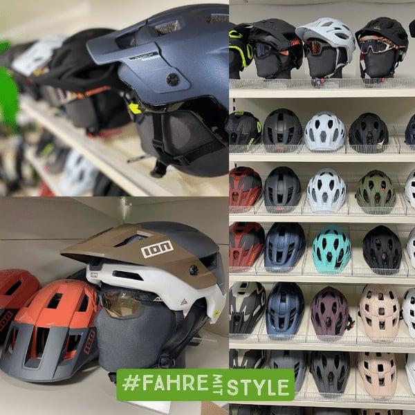 Verschiedene Fahrradhelme in einem Regal ausgestellt